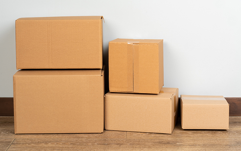 Group of brown carton boxes on wooden floor